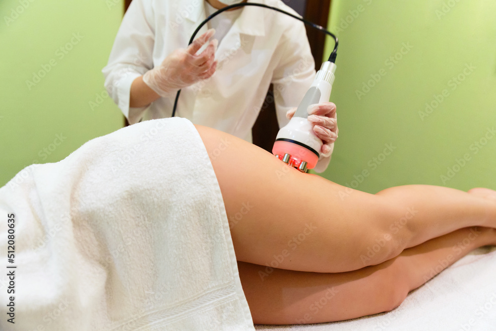 Fototapeta premium Anti-cellulite massage RF-lifting of thighs.
