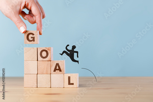Running man silhouette climbing to cubes of goals. New business targets icon on wooden cube