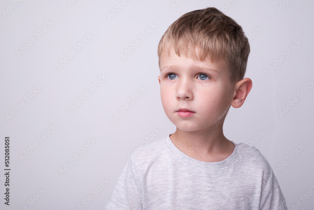 A boy with blond hair and a sad expression A boy with blond hair and a sad expression