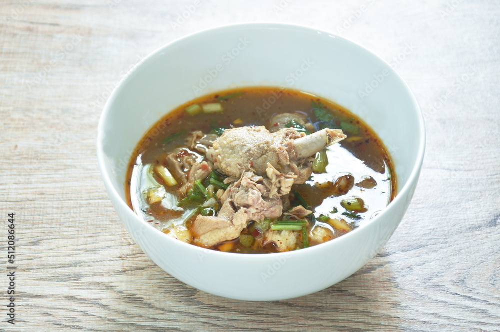 hot and spicy duck meat with tamarind and Thai herbs soup on bowl hot and spicy duck meat with tamarind and Thai herbs soup on bowl