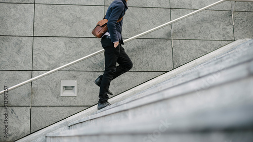 Businessman going to work in the city walking in the street.