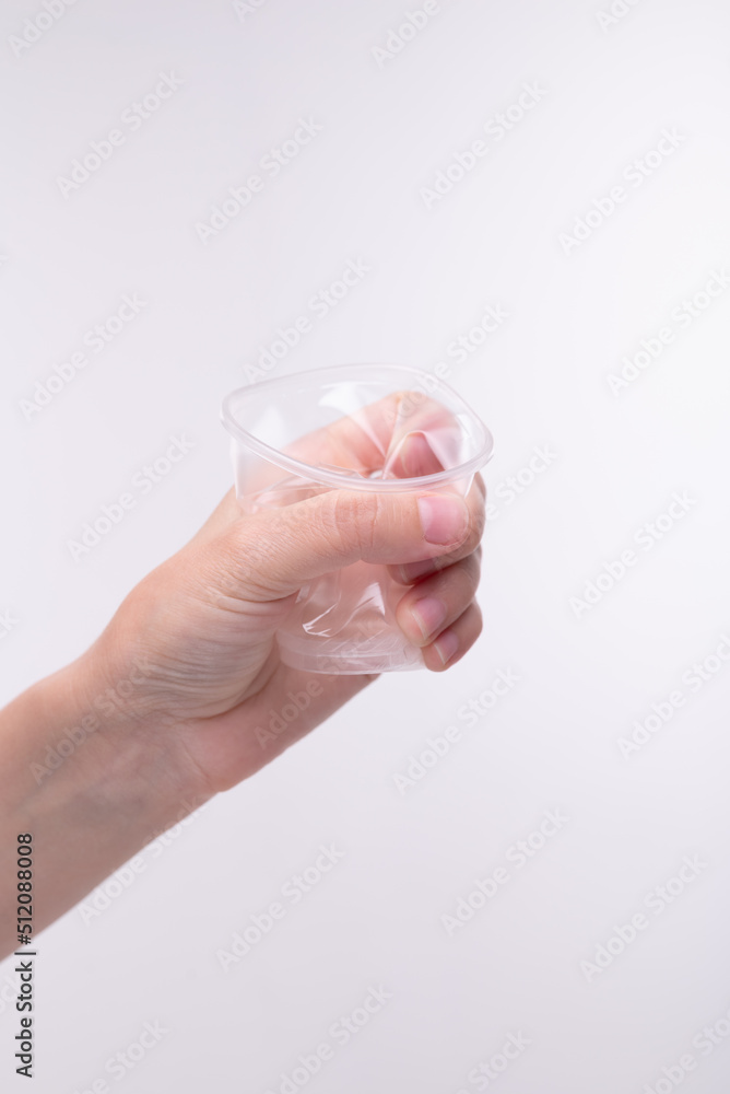 Plastic cup crumpled in hand Plastic cup crumpled in hand
