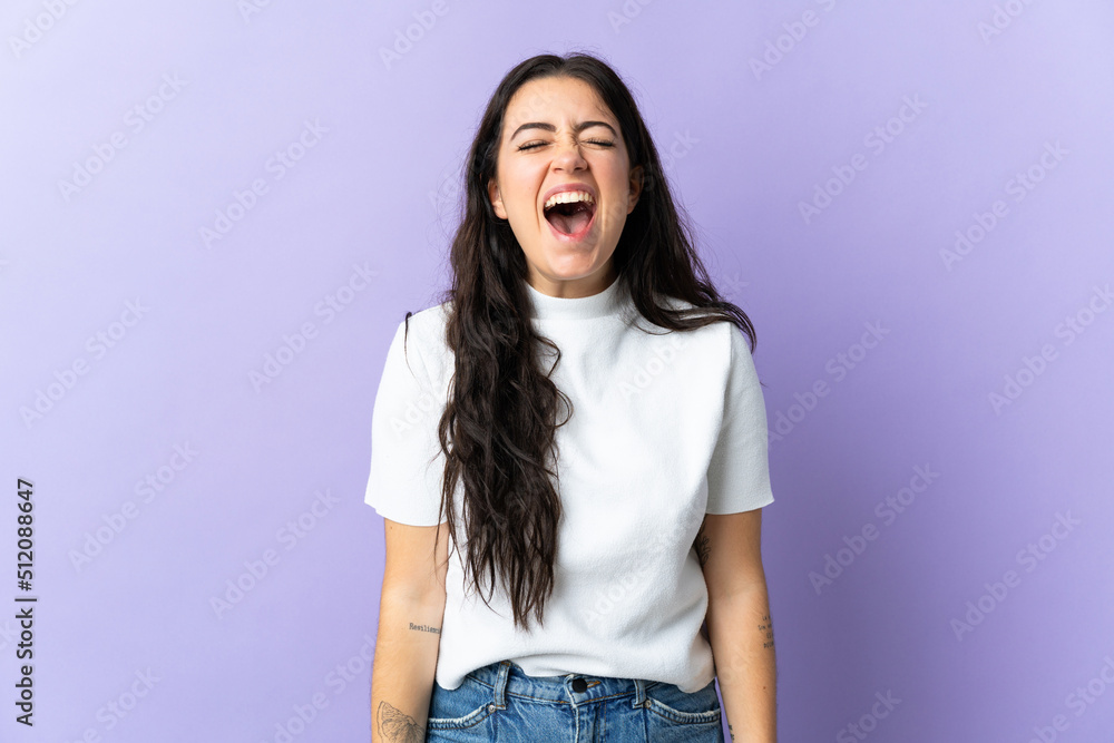 Young caucasian woman isolated on purple background shouting to the front with mouth wide open Young caucasian woman isolated on purple background shouting to the front with mouth wide open