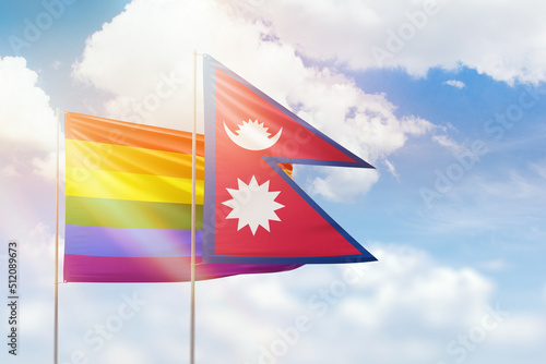 Sunny blue sky and flags of lgbt and nepal