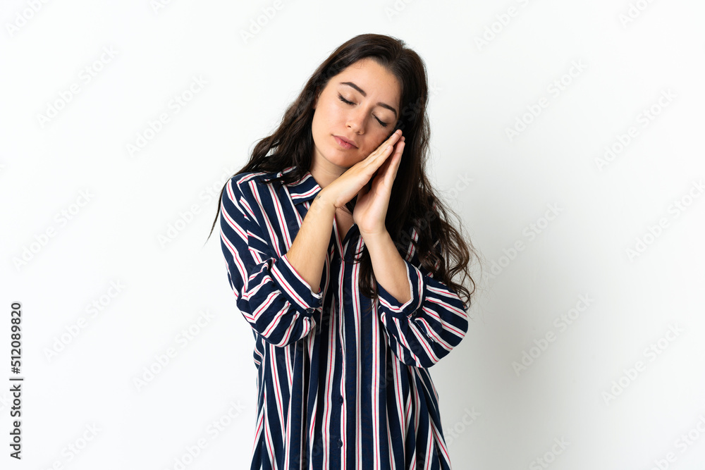 Young caucasian woman over isolated background making sleep gesture in dorable expression Young caucasian woman over isolated background making sleep gesture in dorable expression