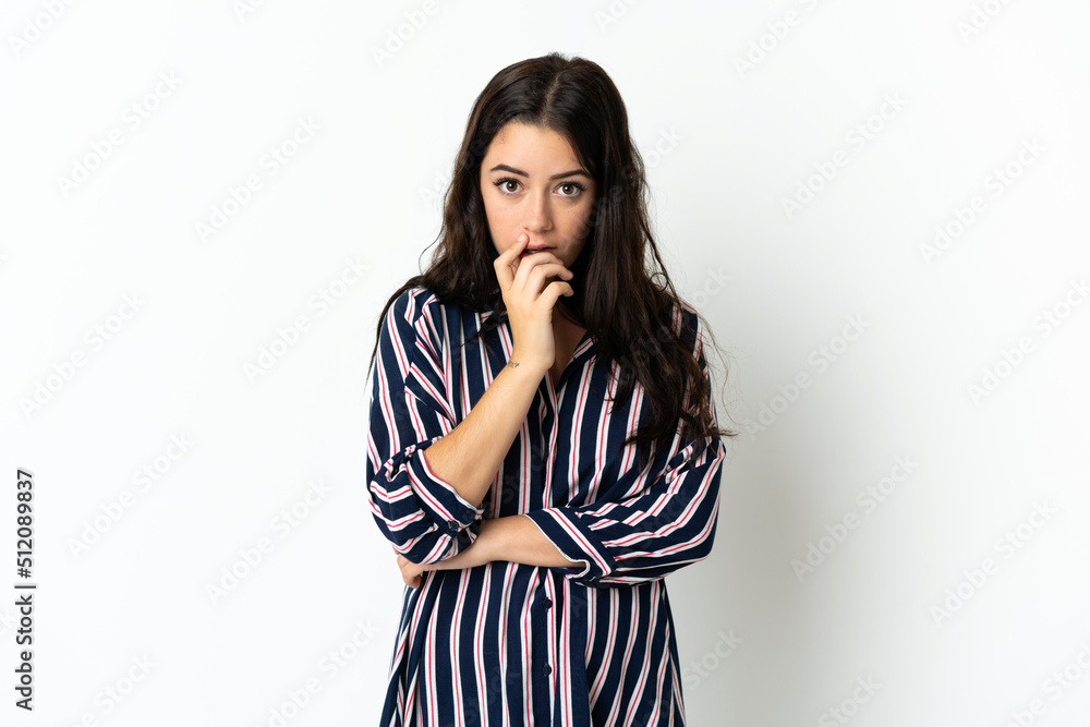 Young caucasian woman over isolated background surprised and shocked while looking right Young caucasian woman over isolated background surprised and shocked while looking right