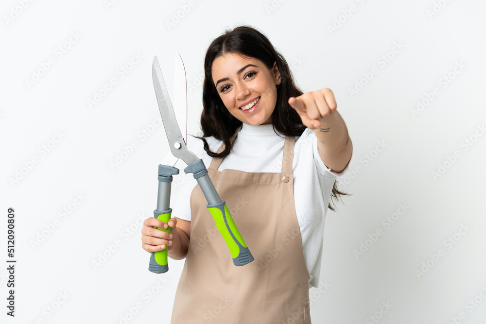 Young caucasian woman holding a plant isolated on white background pointing front with happy expression Young caucasian woman holding a plant isolated on white background pointing front with happy expression