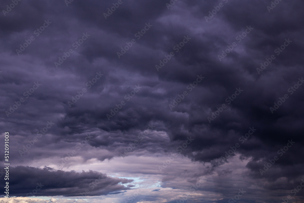 Storm sky with dark blue violet cumulus rainy clouds background texture, thunderstorm