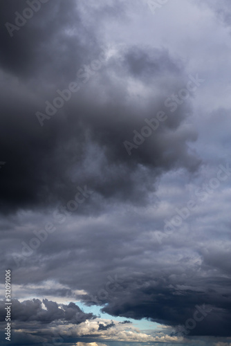 Storm cloudy dramatic sky with dark rain grey cumulus cloud and blue sky background texture, thunderstorm, heaven