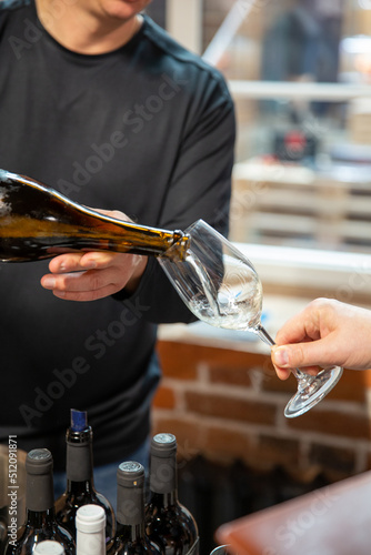 White wine is poured into a glass. Festive party