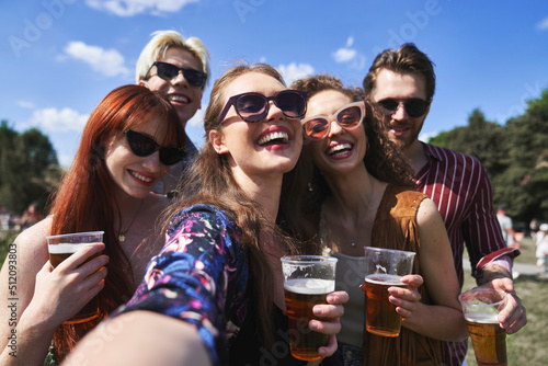 Group of young caucasian friends taking selfie with beer during music festival © gpointstudio