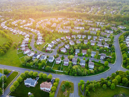 Фотография Aerial panorama view of a small town city home roofs at suburban residential qua