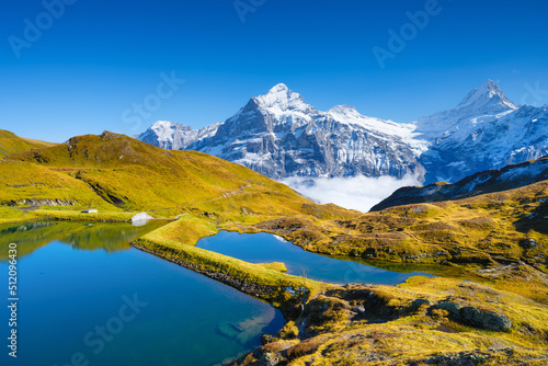 Grindelwald, Switzerland. High mountains and reflection on the surface of the lake. Mountain valley with lake. Landscape in the highlands in the summertime. photo