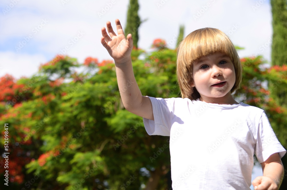 Cute little boy. A three-year-old child is a portrait in nature, in gardens, a tree in bloom. Space for text, positive kid smiling on a sunny summer day Cute little boy. A three-year-old child is a portrait in nature, in gardens, a tree in bloom. Space for text, positive kid smiling on a sunny summer day