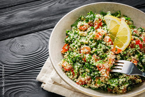 arabic salad tabbouleh on a black rustic wooden background photo