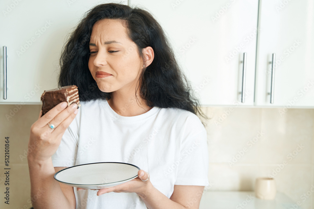 Young female experiencing aversion to sweet food Young female experiencing aversion to sweet food