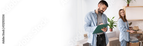 Konstfotografi casual couple checking things to do on clipboard, woman and man working in team while making relocation issues together and taking notes