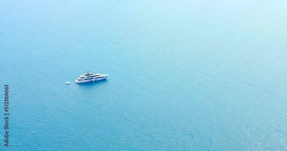 High angle shot of boat visible in distance by sea at daytime. Private luxury yacht. 4K High angle shot of boat visible in distance by sea at daytime. Private luxury yacht. 4K