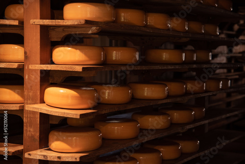 Enkhuizen, Netherlands, June 2022. Close up of a cheese warehouse. The cheeses are stacked on the shelf.