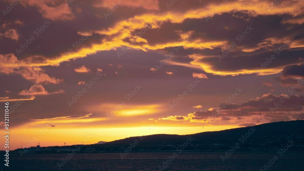 Beautiful dramatic sunset with colorful cloudy sky over mountain and sea. Beautiful dramatic sunset with colorful cloudy sky over mountain and sea.