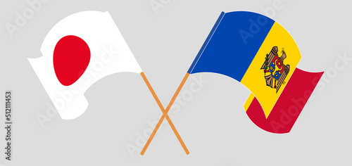 Crossed and waving flags of Japan and Moldova