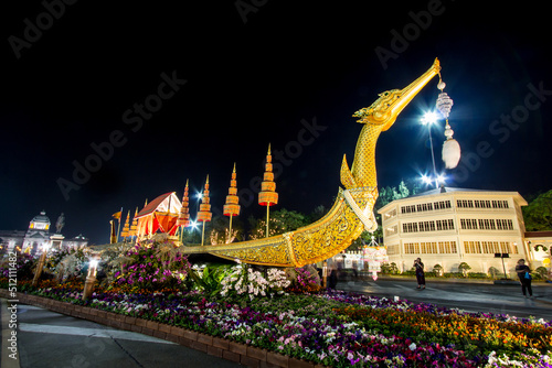 Photography Royal winter festival,Oon Ai Rak Klay Kwam Nao,at Royal Plaza,Dusit Palace and Sanam Suea Pa,Bangkok,Thailand on February16,2018:Replica of Royal Barge Suphannahong with colorful flowers at the base