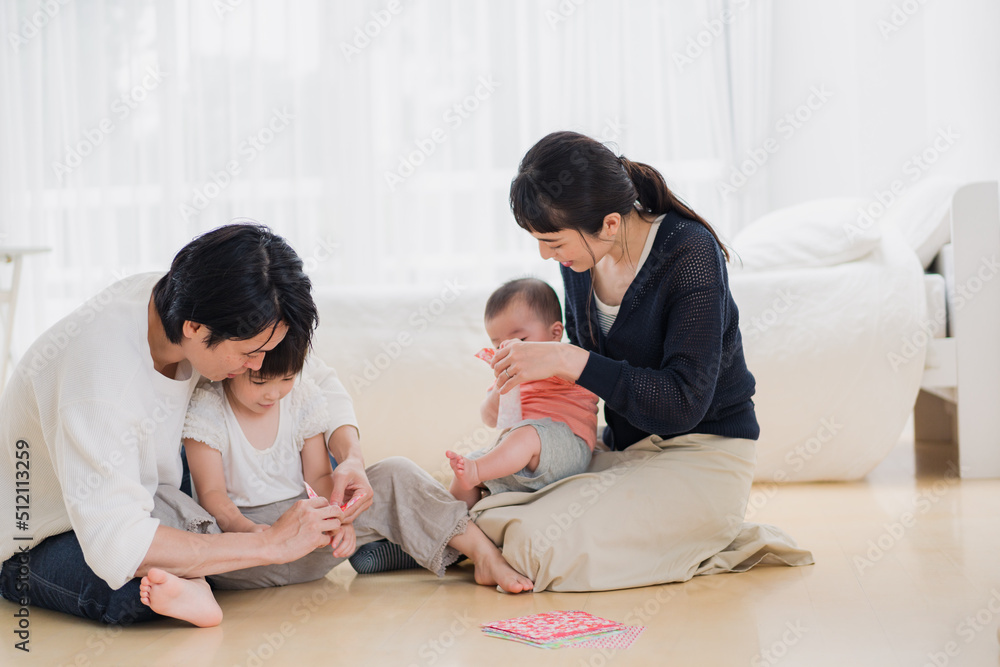 お家で折り紙遊びをする家族
