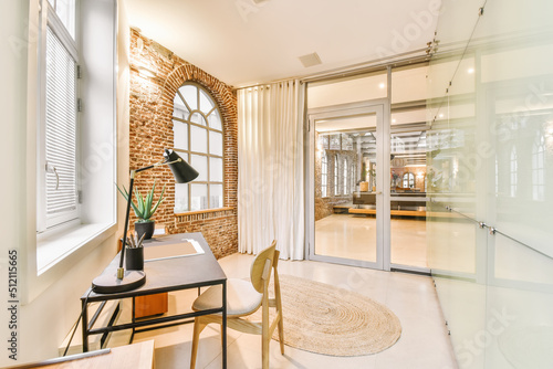 Stylish workroom with table at wall