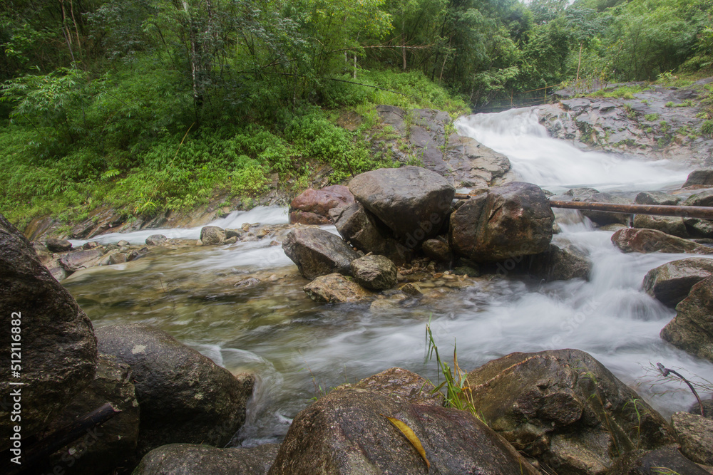 Small waterfall with crystal clear water stream near the campground on the way to Pitugro Waterfall(Petro Lo Su) in Umphang Wildlife Sanctuary,Tak Province,Thailand. Small waterfall with crystal clear water stream near the campground on the way to Pitugro Waterfall(Petro Lo Su) in Umphang Wildlife Sanctuary,Tak Province,Thailand.