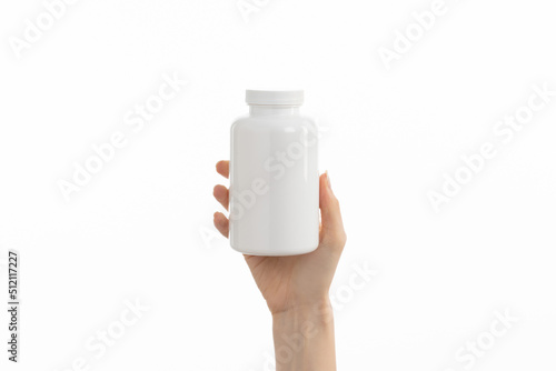 Close up image of woman holding a white bottle