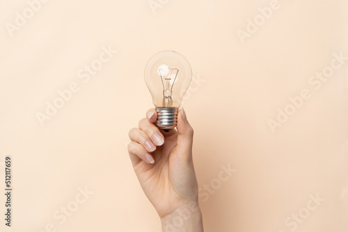 A close up image of wonas hand with light bulb