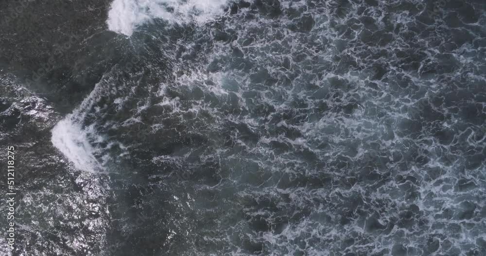Wavy surface of sea or ocean. Big waves with white foam, splashing each other. Drone view, aerial shot. Chilling, relaxing atmosphere. Salty water, high tide concept Wavy surface of sea or ocean. Big waves with white foam, splashing each other. Drone view, aerial shot. Chilling, relaxing atmosphere. Salty water, high tide concept