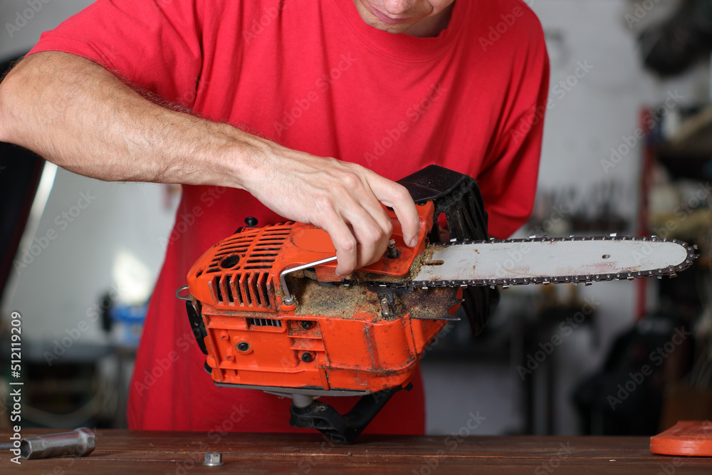 cleaning and maintenance of the chainsaw by a person on a table cleaning and maintenance of the chainsaw by a person on a table