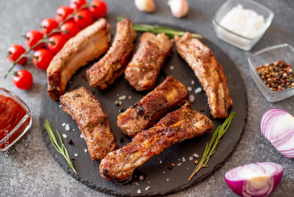 grilled pork ribs on a stone background grilled pork ribs on a stone background