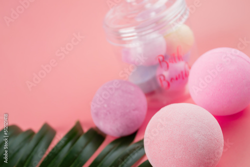 salt bombs for a spa on a pink background with copy space