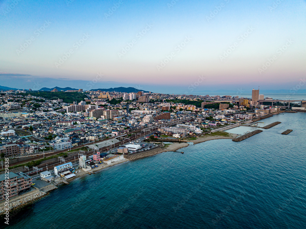 Fototapeta premium Sunset glow over condos in coastal town