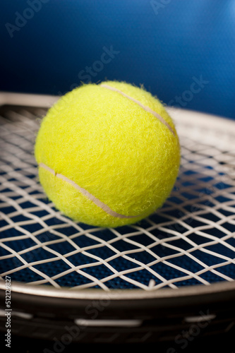 yellow tennis ball and racket close up