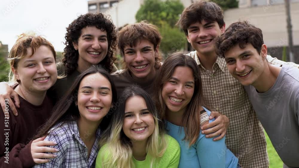 Diverse young people smiling on camera outside of university
Diverse young people smiling on camera outside of university