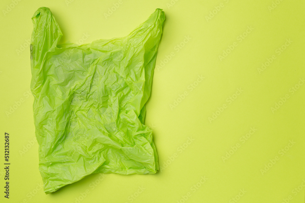 Disposable plastic bag on color background, top view