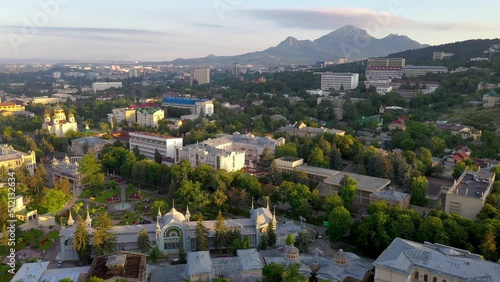 Forward reveal aerial shot of Pyatigorsk town and Beshtau mount at sunrise. Stavropol Krai, Russia. photo