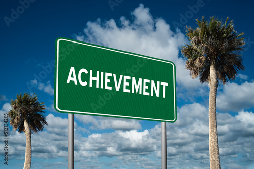 Highway sign with the word Achievement on a beautiful blue sky background with palm trees.  Motivational concept for finding what we want on the journey of life.