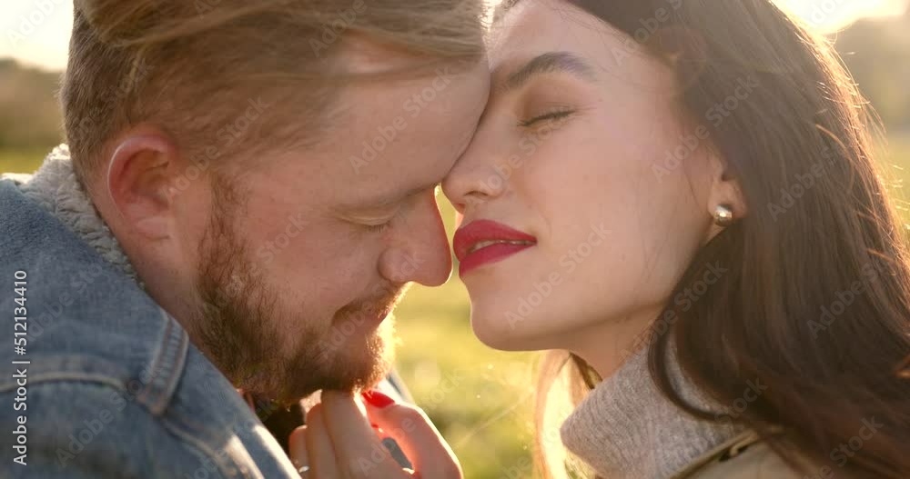 Loving couple hugging and kissing on meadow Loving couple hugging and kissing on meadow