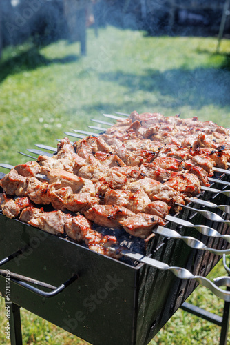 Fotografi Marinated shashlik cooking on a charcoal grill