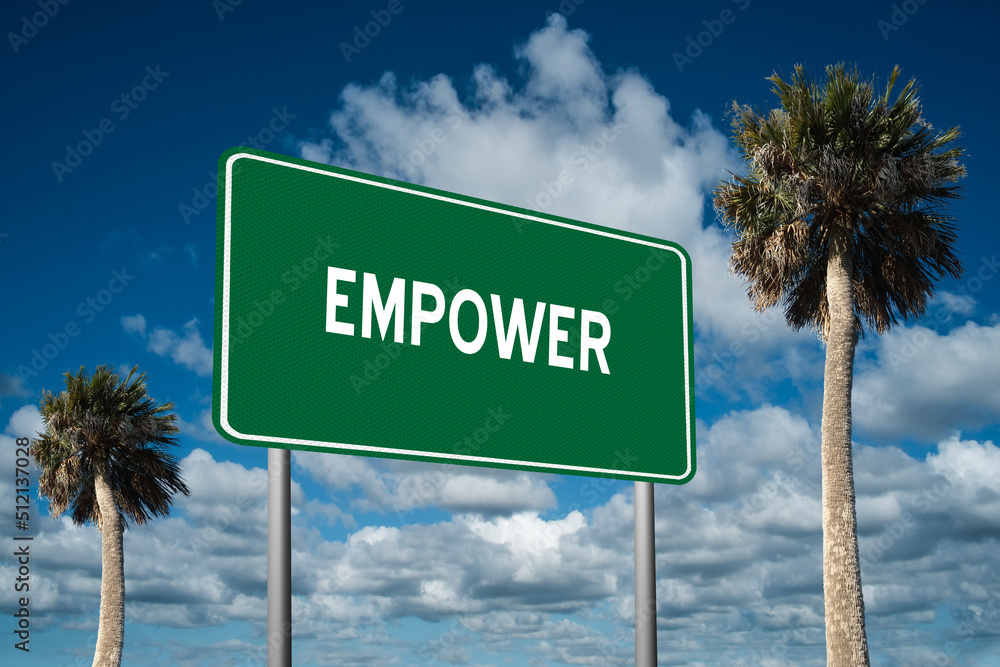 Fototapeta premium Highway sign with the word Empower on a beautiful blue sky background with palm trees. Motivational concept for finding what we want on the journey of life.