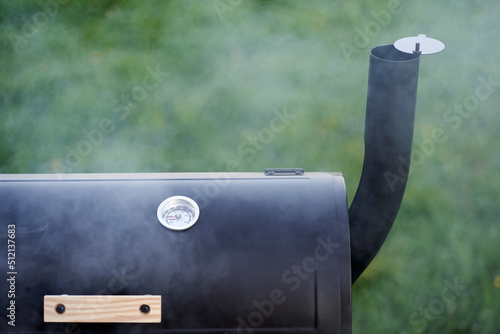 Billede på lærred Close up of new smoker grill surrounded by steam