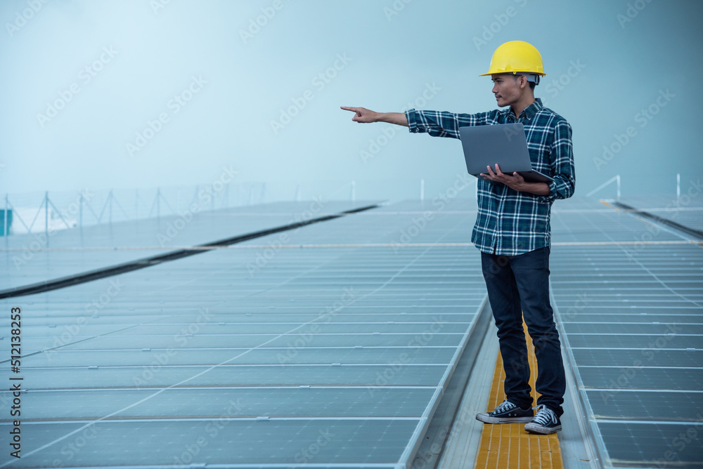 Technician works at a solar power station, Technology solar cell, Engineer check installation solar cell on the roof of factory. Technician inspection and repair solar cell on the roof of factory. Technician works at a solar power station, Technology solar cell, Engineer check installation solar cell on the roof of factory. Technician inspection and repair solar cell on the roof of factory.