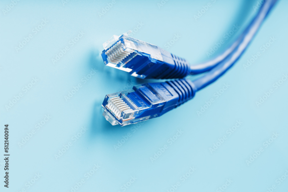 Blue Ethernet Cable Cord Patch cord on a blue background with free space