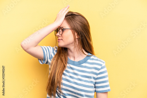 Young caucasian woman isolated on yellow background forgetting something, slapping forehead with palm and closing eyes.