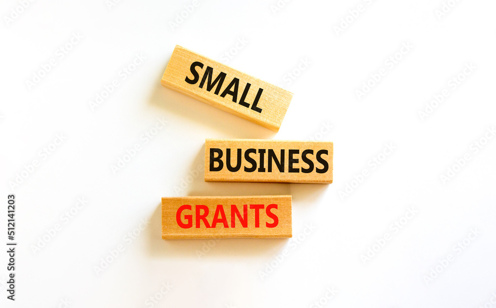 Small business grants symbol. Concept words Small business grants on wooden blocks on a beautiful white table white background. Business, finacial and small business grants concept. Small business grants symbol. Concept words Small business grants on wooden blocks on a beautiful white table white background. Business, finacial and small business grants concept.