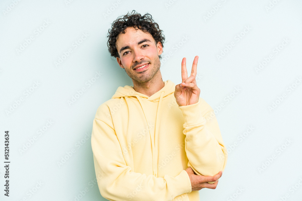 Young caucasian man isolated on blue background showing number two with fingers. Young caucasian man isolated on blue background showing number two with fingers.